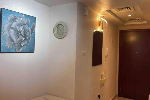 a bathroom with a picture of a flower on the wall at Sea view first line Studio Shj in Sharjah