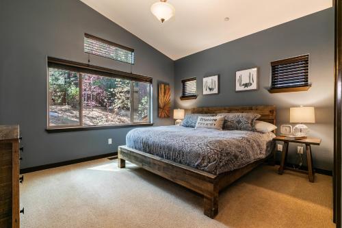 a bedroom with a bed and a window at Pinecrest at Winter Creek- Cozy Cabin w Hot Tub, Walk To Downtown Truckee in Truckee