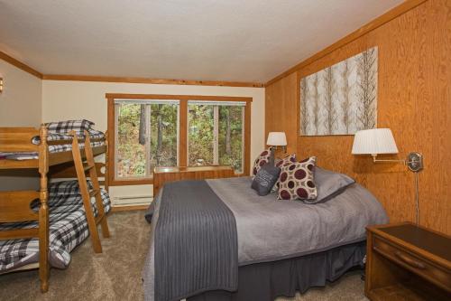 a bedroom with a bed and a ladder and a window at Palisades Tahoe Ski Condo - Remodeled 2 BR, Walking Distance to Lifts & Village in Olympic Valley
