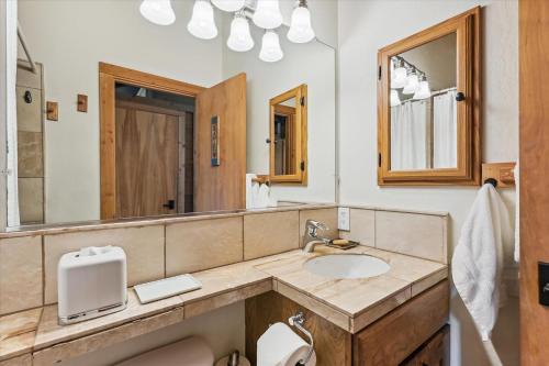 a bathroom with a sink and a mirror at Rocky Point # 4 - 2 BR Northstar Condo, Shuttle to Slopes, HOA Amenities! in Truckee
