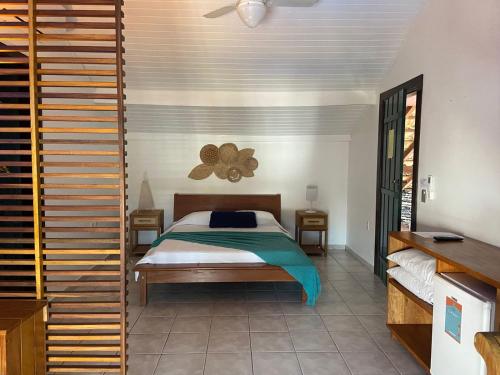 a bedroom with a bed in a room at Casa Aldeia Paraty in Paraty