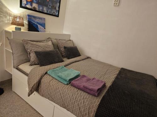 a bed with two pillows on it in a bedroom at The Northern Light Apartment in Jukkasjärvi