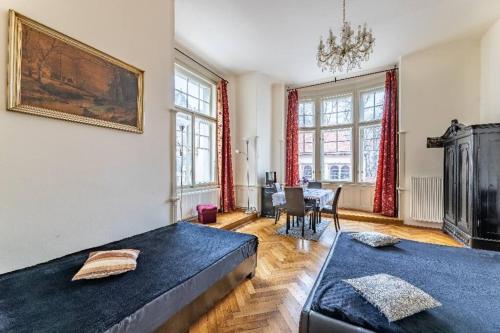 a bedroom with two beds and a dining room with a table at Cosy Apartment for 4 / Old Town / Jewish Quarter in Prague