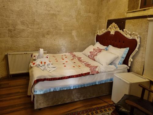 a bedroom with a bed with a doll on it at Born Hotel in Urgup