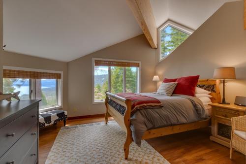 a bedroom with a bed and two windows at Tahoe Point of View - Amazing Lake Views at this 4BR w Hot Tub, Sauna, Near Skiing in Tahoe City