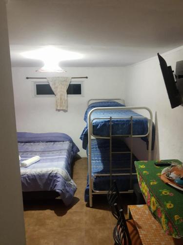 a room with two bunk beds and a light at dormi La familia in Malargüe