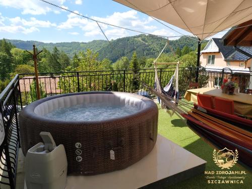 een hot tub op het balkon van een huis bij Szczawnica Residence "Nad Zdrojami" - In the Heart of Recreation 691-739-603 in Szczawnica