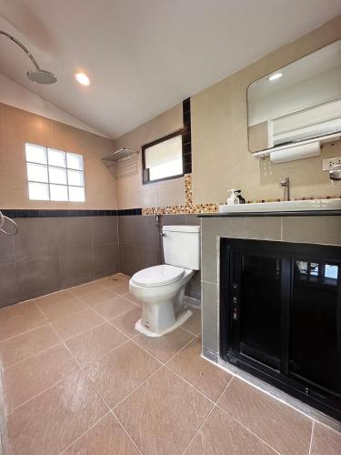 a bathroom with a toilet and a sink at Scenery Sunrise in Chaweng Noi Beach
