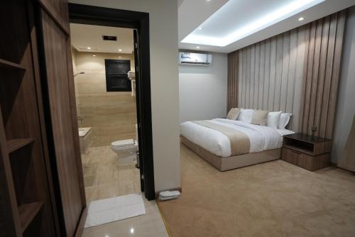 a hotel room with a bed and a bathroom at Awrad Royal 2 in Riyadh