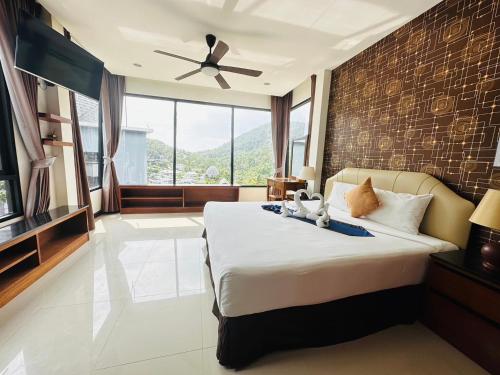 a bedroom with a large bed with a brick wall at Scenery Sunrise in Chaweng Noi Beach