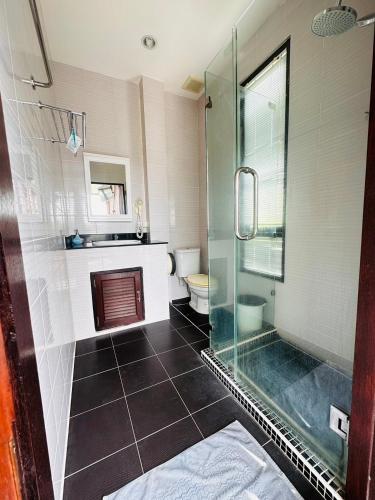a bathroom with a glass shower and a toilet at Scenery Sunrise in Chaweng Noi Beach