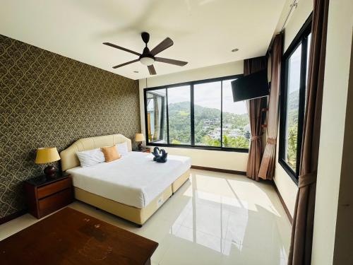 a bedroom with a bed and a large window at Scenery Sunrise in Chaweng Noi Beach