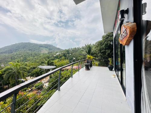 a balcony with a view of a mountain at Scenery Sunrise in Chaweng Noi Beach