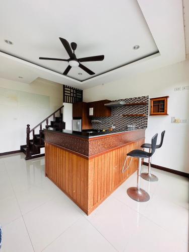 a bar in a room with a ceiling fan at Scenery Sunrise in Chaweng Noi Beach
