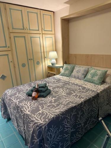 a bedroom with a bed with a teddy bear on it at Studio flat in Sardinia Costa Smeralda in Porto Rotondo