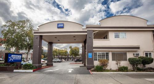 a building with a parking lot in front of it at Americas Best Value Inn - Chico in Chico