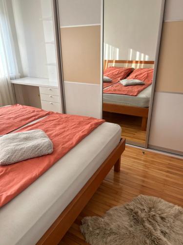 a bedroom with two beds and a mirror at Vills 36 Place in Sarajevo