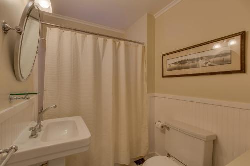a white bathroom with a sink and a toilet at Vanni House - Classic Tahoe Style 2 BR - Sleeps 6 - Hot Tub - Near Palisades & Downtown Tahoe City in Tahoe City