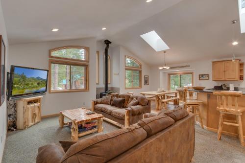 a living room with a large couch and a kitchen at Tahoma Charm on West Shore - Beautiful Open Concept 3 BR w Private Hot Tub in Tahoma