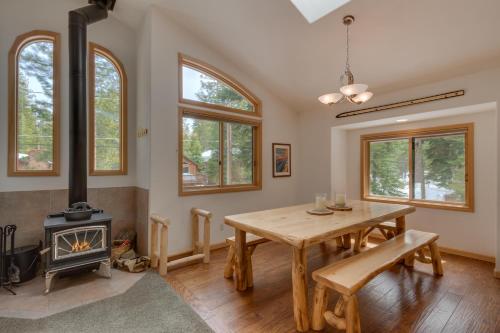 a dining room with a table and a wood stove at Tahoma Charm on West Shore - Beautiful Open Concept 3 BR w Private Hot Tub in Tahoma