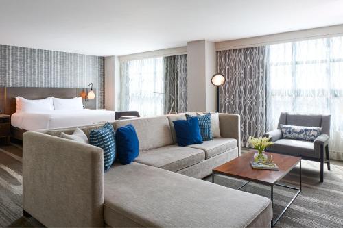 a living room with a couch and a bed at Renaissance Los Angeles Airport Hotel in Los Angeles