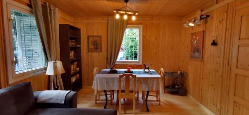 a dining room with a table and chairs in a room at Casa NOR in Tarcău-Gheuca