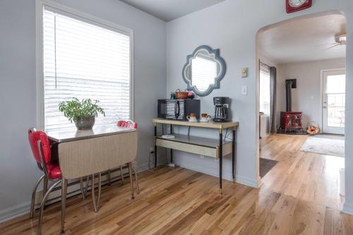 a dining room with a table and a desk in a room at Serendipity Cottage in Joseph
