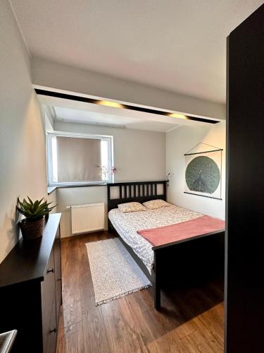 a bedroom with a bed and a table in it at Katowice City Centre III in Katowice