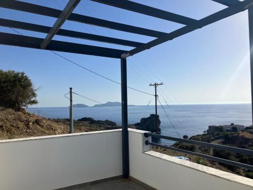 a view of the ocean from the balcony of a house at Anifora Seaview Villa in Agios Pavlos