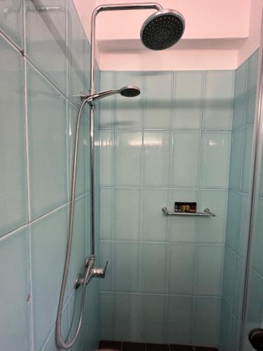 a shower with a shower head in a bathroom at Anifora Seaview Villa in Agios Pavlos