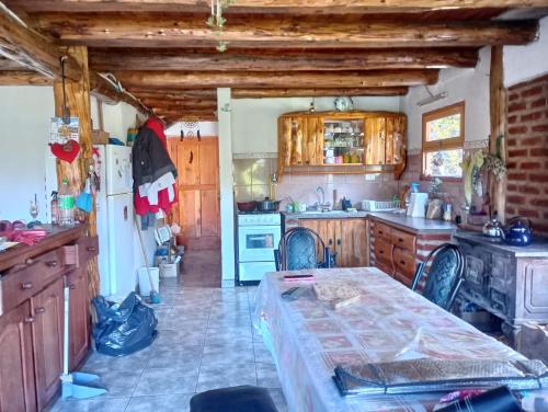 a kitchen with a table in the middle of it at Malegus in Epuyén