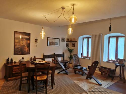 a living room with a table and chairs at B&B Il Mulino alla Busa in Vallarsa