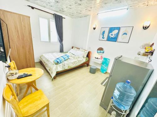 a small room with a bed and a table at Cozy & Quiet 1BR Oasis in the heart of Ho Chi Minh City in Ho Chi Minh City
