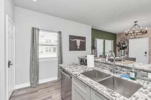 a kitchen with a sink and a counter top at TEXAS-Style 2 BR Apartment near NRG Stadium, University of Houston, Med Center, Gated, Wifi, Parking in Houston