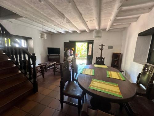 a dining room with a wooden table and chairs at Cabañas Coloniales con Entorno Natural en Barichara in Barichara