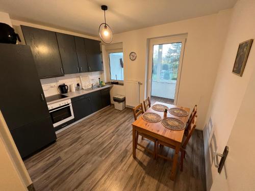 a kitchen and dining room with a table and chairs at Pluto in Gelsenkirchen