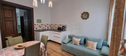 a living room with a blue couch and a table at Luxury Central apartment in Sibiu in Sibiu