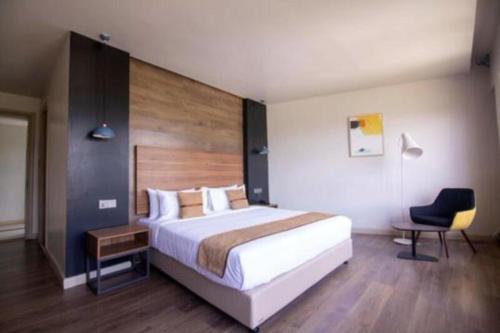 a bedroom with a bed and a desk and a chair at Eseriani The Resort in Naivasha