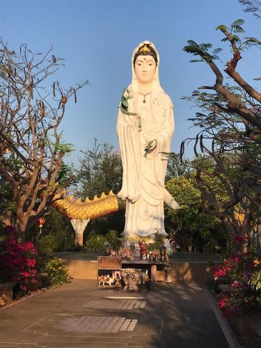 a large statue of a woman standing in a garden at S&F villa in Sam Roi Yot