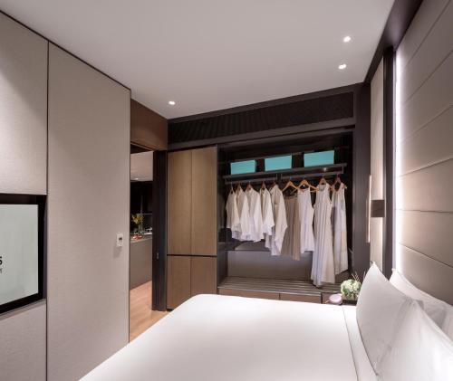 a bedroom with a bed and a closet at Fraser Residence River Promenade, Singapore in Singapore