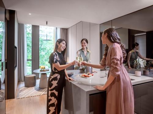 a group of women standing in a kitchen at Fraser Residence River Promenade, Singapore in Singapore