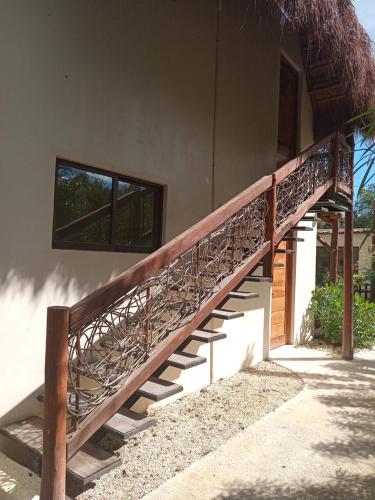 a wooden staircase on the side of a building at Villa AHAL, in Chemuyil