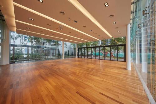 an empty room with a wooden floor and large windows at Grand Medini, Iskandar Puteri, Johor in Nusajaya