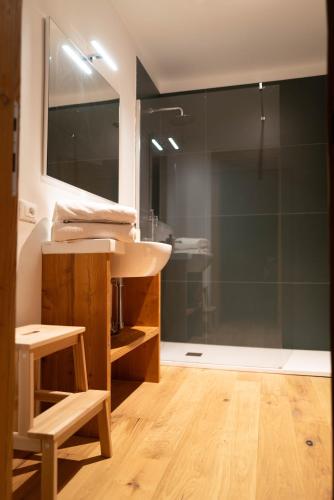 a bathroom with a sink and a glass shower at White Escape in Valtournenche