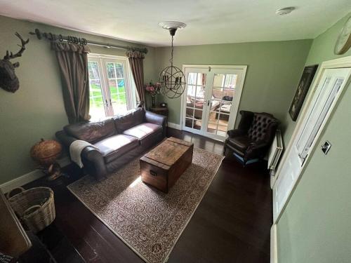 a living room with a couch and a coffee table at Jaw Dropping House with Private Indoor Pool and Hot Tub in Peover Superior