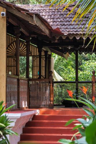 a pavilion with stairs leading to a building at Villa Sereno by Insignia Villas in Assagao