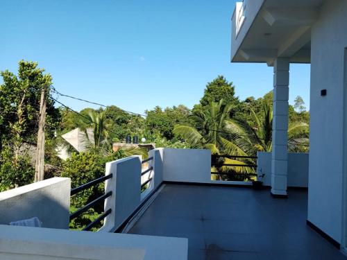 a balcony of a house with a view of trees at Dream Villa in Matara