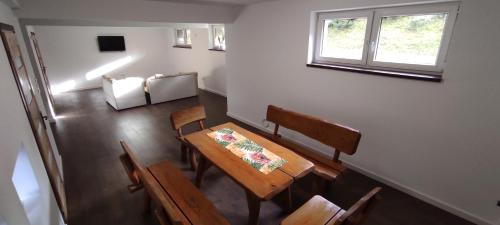 a dining room with a table and chairs and a window at Gliczarowski gościniec in Gliczarów