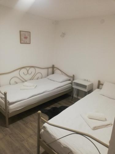 a room with two beds and a table at Vila Budimir in Pirot