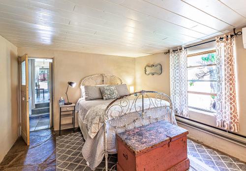 a bedroom with a metal bed and a window at Pet Friendly Piñon Heaven in Santa Fe